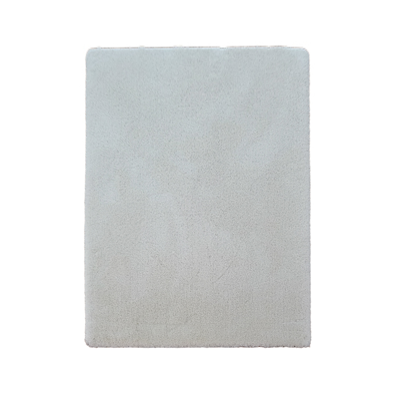 What are the differences in feel, durability, and stain resistance between natural wool and regenerated cellulose fibers in solid-color carpets?